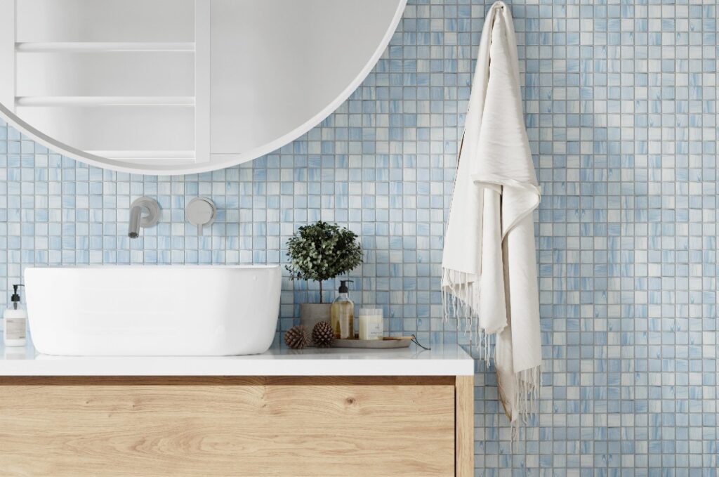Eine Ecke des Hotelbadezimmers mit weiß-blau gefliesten Wänden, einem großen weißen Spiegel und einer Dusche. Im skandinavischen Stil. 3D-Rendering